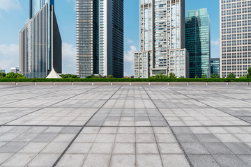 Fototapeta na wymiar Empty square floor tiles and skyline of modern urban buildings in Shanghai..