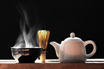 Hot matcha green tea on a black background 