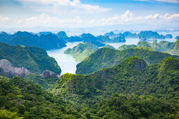 scenic view over Ha Long bay from Cat Ba island, Ha Long city in the background, UNESCO world heritage site, Vietnam