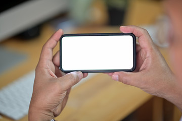 Closeup of male hands holding blank screen mobile smart phone