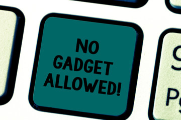 Fototapeta premium Writing note showing No Gadget Allowed. Business photo showcasing do not enter small mechanical or electronic device or tool Keyboard key Intention to create computer message pressing keypad idea
