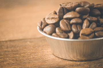 Coffee beans on a wooden background. Copy space.