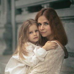 Obraz na płótnie Canvas Beautiful portrait of a mother holding daughter