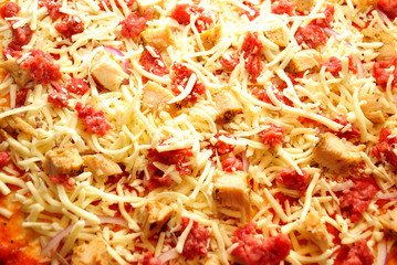 Close-Up of Raw Ground Beef & Chicken Pizza