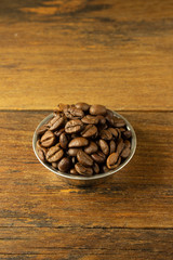 Obraz na płótnie Canvas Coffee beans on a wooden background. Copy space.