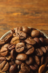 Coffee beans on a wooden background. Copy space.