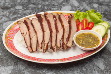 Fried pork with garlic or steak on rice and cucumber.