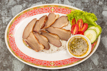 roasted duck meat topping rice dressing sweet sauce and pickled ginger on plate