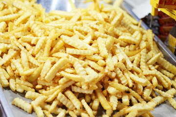 fried potatoes as background at market in Thailand
