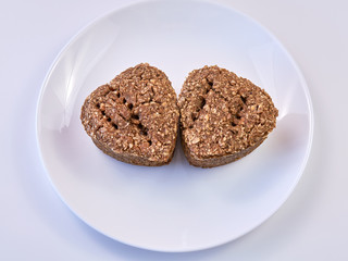 wheat germ bread and rye on a white round plate. healthy food. homebaked bread.