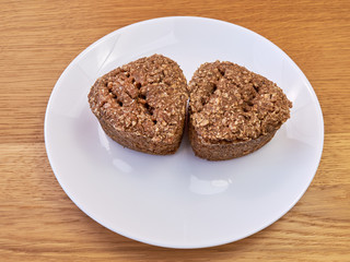 homemade rye bread lying on a white plate. top view