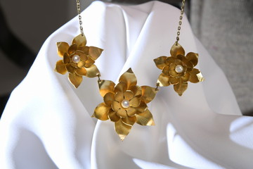 Vintage brass jewelry necklace with pearl on the white satin, hand made