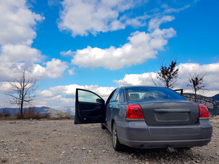 Obraz na płótnie Canvas car back doors wheels sky clouds spring nature mountains adventrure