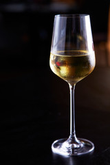 Glass of white wine on table