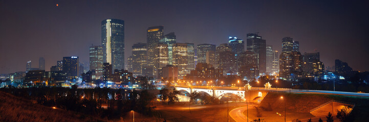 Fototapeta na wymiar Calgary downtown cityscape with skyscraper and bridge at night, Canada.