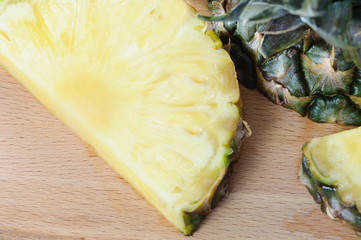 Flat lay of pineapple cut in slice. wooden table. Top view, overhead.
