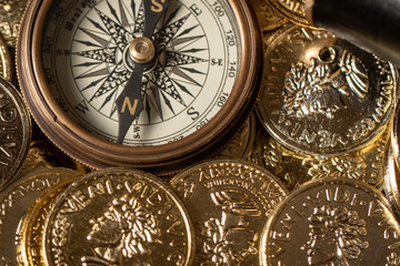 Fototapeta na wymiar Vintage compass and gold treasure top view
