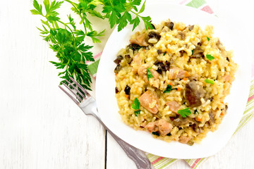 Risotto with mushrooms and chicken on light board top