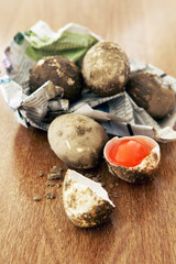Fresh raw salted egg on wooden table