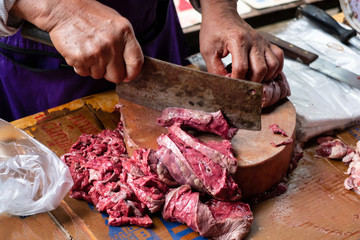 Meat merchant cust beaf on the wood chopping board.