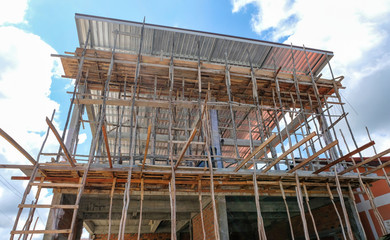 Home under construction with wood scaffolding