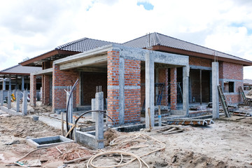 Unfinished single one storey house in housing estate. House construction.