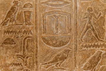 Ancient egyptian hieroglyphs carved on the stone wall