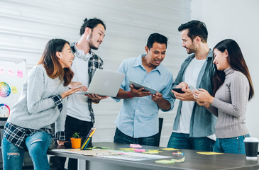 Diversity Designer in casual cloth using technology device at meeting table in meeting room at creative office.