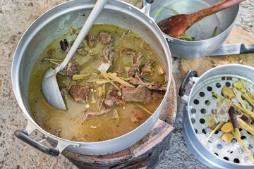Top view of duck soup in pot on stove. Thai style menu recipe.
