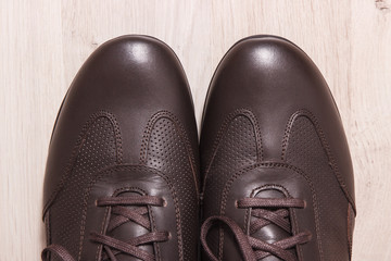 Comfortable brown leather shoes on board, male footwear