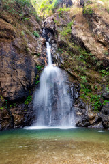Fototapeta na wymiar Small waterfall in rain forest in National park in Karnchanaburi province in Thailand.