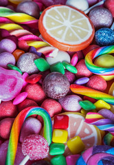 Fototapeta na wymiar lies a lot of chewing gum, candy, candy and other sweets rainbow