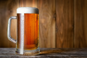 mug of beer on wooden table