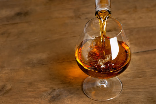 Brandy Or Cognac Pouring Into Glass