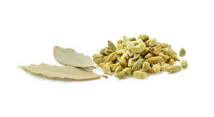 Green cardamom and bay leaves on white background