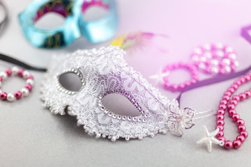 A festive,Beautiful white mardi gras or carnival mask on beautiful colorful paper background