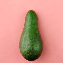 Fresh organic avocado isolated. Color of year 2019 Living Coral concept. Coral background with avocado.