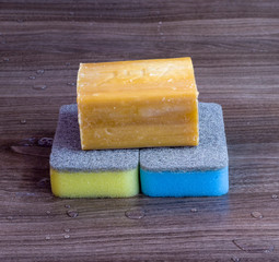 A large piece of soap and two sponges to clean the dishes