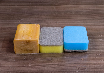 Two cleaning sponges and a bar of soap
