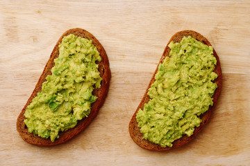 sandwich with guacamole on wood top view