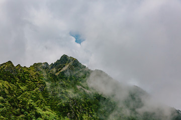 Mountain ridges covered by clouds and fog on top of Cangshan Mountains in Dali, Yunnan, China