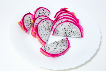 dragon fruit sliced ​​lies on a white plate