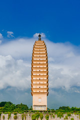 One of the three pagodas of Chongsheng Temple against Cangshan Mountains covered in clouds in Dali,...