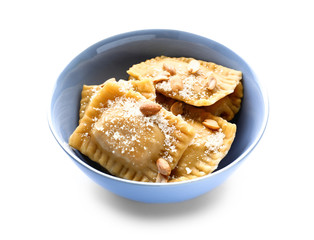 Bowl with tasty ravioli on white background
