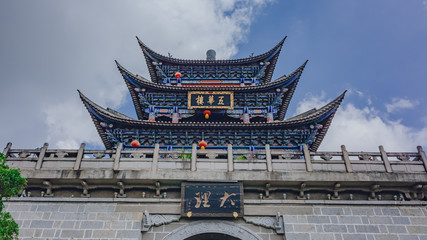 Traditional Chinese gate tower building in old town of Dali under sky and clouds, in Dali, Yunnan,...