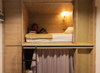 Interior view of capsule bedroom in hostel. Capsule bedroom, bed in box or pod. Small simple bedroom interior design with modern and luxury style in Bangkok Thailand. - obrazy, fototapety, plakaty