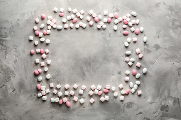 Frame made of sweets on grey background