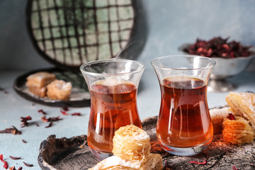 Tray with Turkish tea in traditional glasses and East sweets on table