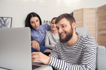 Happy family using laptop at home