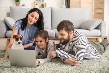 Happy family using laptop at home